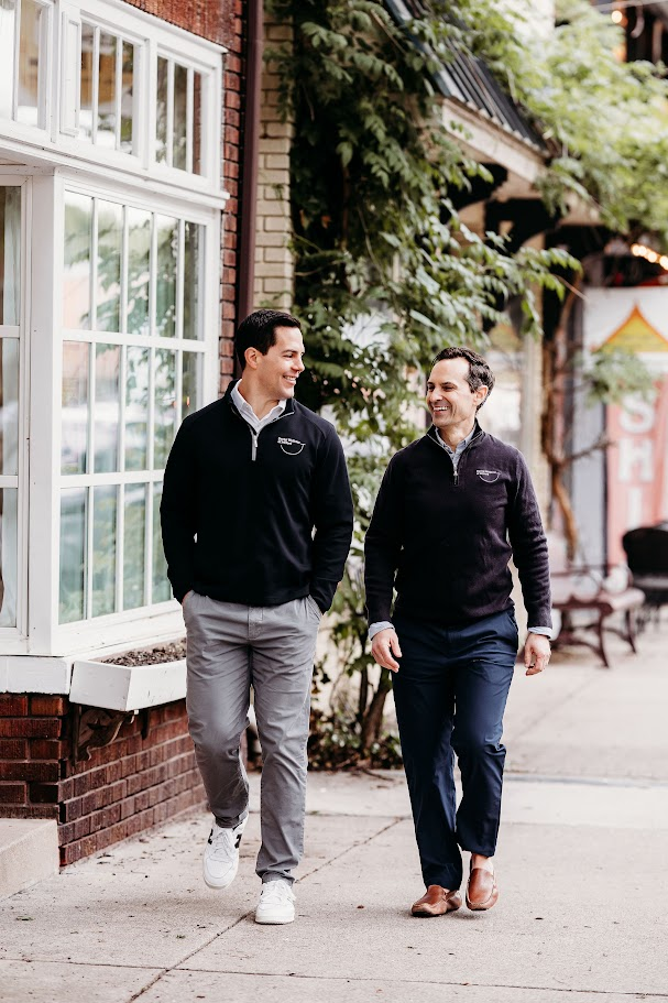 Dr. Johnson and Dr. Evans walking together in downtown Milford